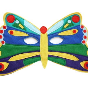 May include: A colorful butterfly mask made of felt. The mask features a yellow outline, with wings in shades of blue, green, and teal. Red and yellow accents are used throughout the design, including the eyes and antennae.