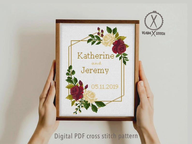 May include: A framed cross stitch pattern featuring a gold geometric frame decorated with red and cream roses and green leaves. The text reads Katherine and Jeremy with the date 05.11.2019. The logo Vlada Stitch is in the top right corner.