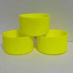 May include: Three bright yellow plastic cups stacked on top of each other.