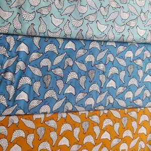 May include: Three fabric swatches with a repeating pattern of white chickens on a blue, teal, and orange background.