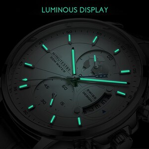 May include: A silver watch with a white face and luminous green hands and markers. The watch face features a small globe and the text "MINUTESTRY 30M WATER" and "SWISS DESIGN".