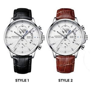 May include: Two silver-toned wristwatches with white faces and black and brown leather bands. Both watches feature a world map design, chronograph functions, and the text "MINUTESTRY 30M WATER" and "SWISS DESIGN".