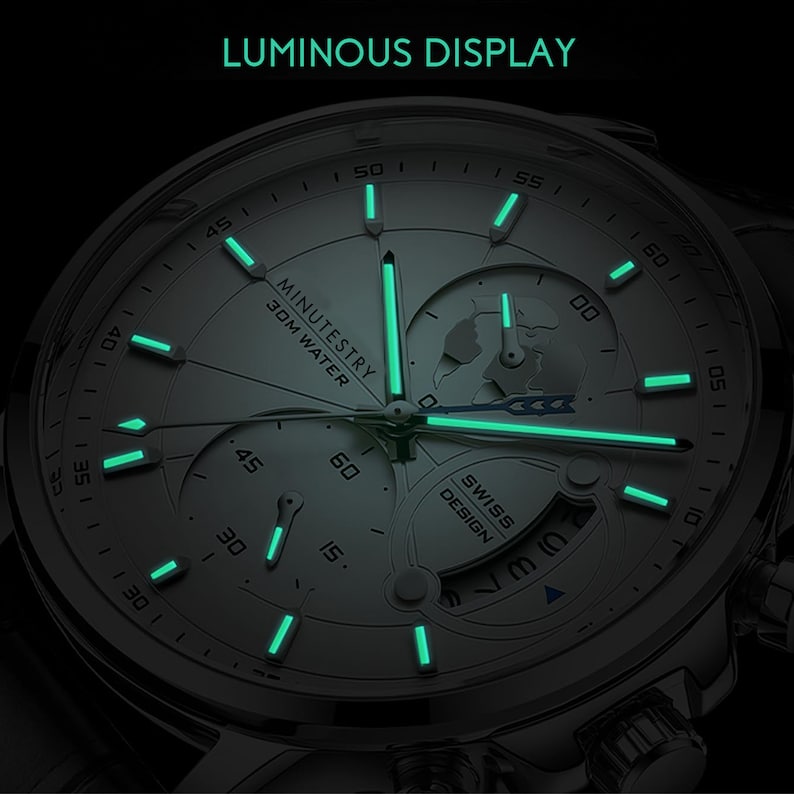 May include: A silver watch with a white face and luminous green hands and markers. The watch face features the text "MINUTESTRY 30M WATER" and "SWISS DESIGN".