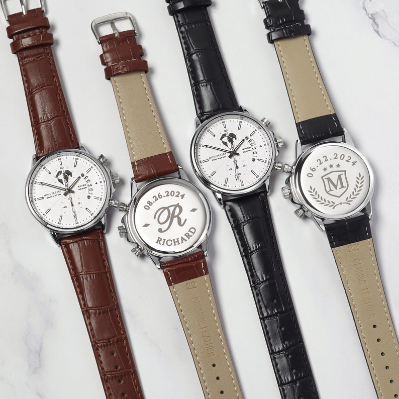May include: Three wristwatches with different colored leather bands. The watches have a white face with silver hands and markers. The back of each watch has a personalized inscription with a date and initials.