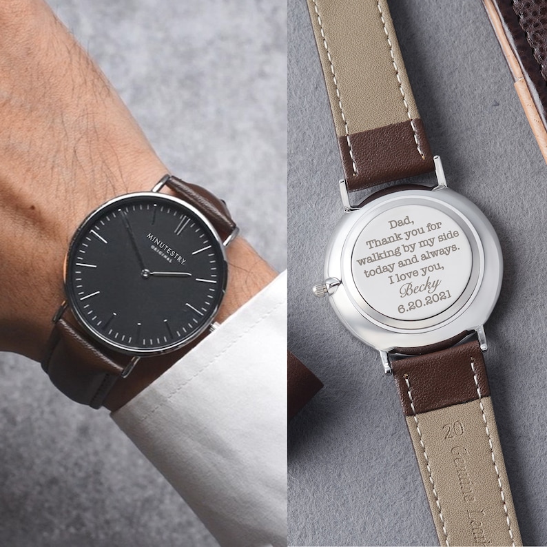 Brown leather wristwatch with custom engraving on the back for a father. Engraving reads: Dad, Thank you for walking by my side today and always. I love you, Becky 6.20.2021. The watch face is black with simple, minimalistic design.