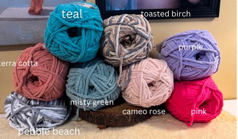 May include: Ten balls of yarn in various colors, including teal, toasted birch, purple, terra cotta, misty green, cameo rose, pink, and pebble beach.