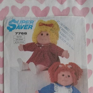 May include: A sewing pattern for two dolls, one with blonde hair and a red dress, and the other with red hair and a blue and white dress. The pattern is called "Super Saver" and the number is 7768.