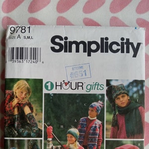 May include: A Simplicity sewing pattern for children's winter accessories. The pattern includes instructions for making a hat, scarf, and mittens. The pattern is illustrated with photos of children wearing the finished accessories.