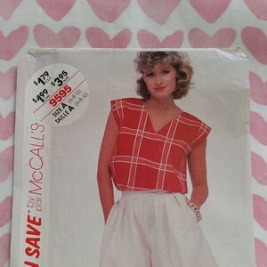 May include: A sewing pattern for a red and white plaid top and white shorts. The pattern is called "Stitch 'n Save" by McCall's and the pattern number is 9595. The pattern is for sizes 6-8-10.