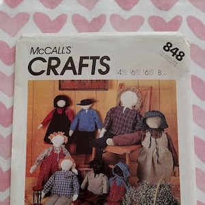 May include: A McCall's Crafts pattern for making folk dolls. The pattern includes instructions for making three sizes of dolls. The pattern cover features a group of dolls dressed in traditional clothing.