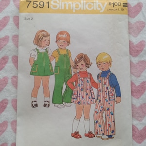 May include: Vintage Simplicity sewing pattern 7591 for children's clothing. The pattern features illustrations of children wearing various outfits, including overalls and dresses. The text on the pattern reads "Top Sized for Stretch Knits Only".