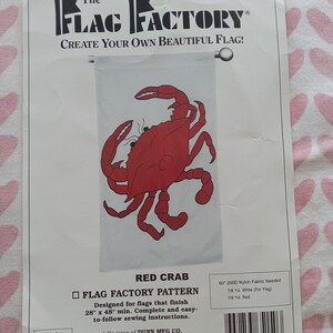 May include: A package for a flag pattern featuring a red crab design. The text reads "The Flag Factory" and "Create Your Own Beautiful Flag!" The pattern is designed for flags that finish 28" x 48" minimum.