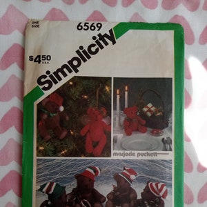 May include: Simplicity sewing pattern number 6569 for making Christmas teddy bears. The pattern includes instructions for making a variety of teddy bears, including a bear playing a drum, a bear playing a trumpet, and a bear holding a gift. The pattern also includes instructions for making a Christmas tree and a candle.