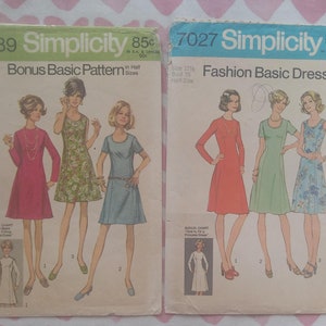 May include: Two vintage Simplicity sewing patterns for dresses. The pattern on the left is for a basic dress and is numbered 8889. The pattern on the right is for a fashion basic dress and is numbered 7027.