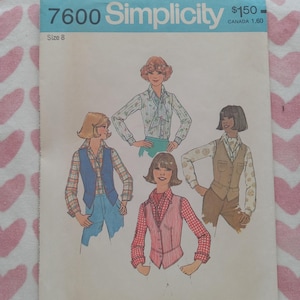 May include: Vintage Simplicity sewing pattern, size 8, featuring illustrations of women's tops and vests. The pattern cover has a blue header with the number 7600 and the Simplicity logo. The background is a pink and white heart pattern.