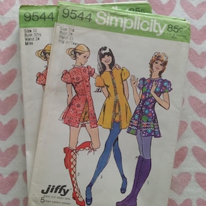 May include: Two vintage Simplicity 9544 sewing pattern envelopes featuring illustrations of three short dresses with puff sleeves. The patterns show size 10 with a 32.5-inch bust and 24-inch waist, and size 7/8 with a 29-inch bust and 23-inch waist.