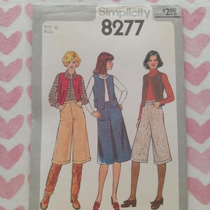 May include: Simplicity 8277 sewing pattern featuring illustrations of three women in 1970s-style outfits. The pattern includes a vest, skirt, and culottes. The pattern is size 10 Miss.