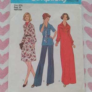 May include: A Simplicity 7181 sewing pattern envelope for size 20 1/2, bust 43. The illustration shows three outfits: a knee-length paisley dress, a blue shirt with a patterned scarf and wide-leg trousers, and a long-sleeved red floor-length dress.