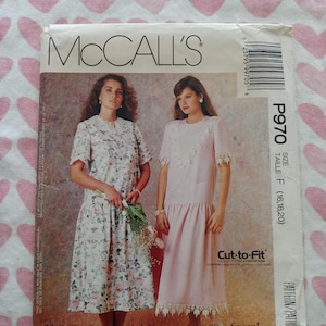 May include: McCall's sewing pattern package featuring two women modeling dresses. The package has the McCall's logo at the top, with the pattern number P970 and size information. The dresses are in floral and solid pink fabrics.