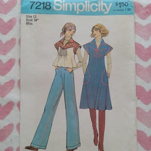 May include: Vintage Simplicity sewing pattern 7218 featuring two 1970s fashion designs. The pattern includes a top with flared pants and a dress with a high collar. The pattern is size 12, bust 34 inches.