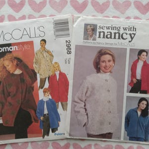 May include: Two vintage sewing pattern envelopes. One features "McCall's Womanstyle" and the number 2968. The other reads "sewing with nancy" and the number 2298. Both show images of women wearing coats and jackets.