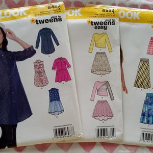 May include: Three sewing pattern packets from New Look, sized for tweens. The packets feature illustrations of dresses, skirts, and tops. The text on the packets includes "easy" and "hour".