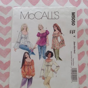 May include: A McCall's M5050 sewing pattern envelope for five variations of a peasant-style blouse with square necklines and drawstring details. The cover features illustrations of tops with various sleeve lengths, including bell sleeves and puff sleeves, in floral and solid fabrics.