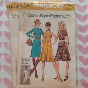 May include: Two vintage Simplicity sewing pattern envelopes, numbers 9547 and 9541, featuring illustrations of three dresses in teal, yellow, and brown floral print. The envelopes include text such as Bonus Basic Pattern and How to Make a Better Fitting Dress.