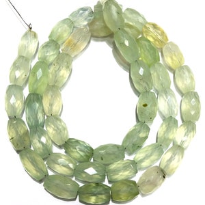 May include: A strand of light green faceted gemstone beads. The beads are oval shaped and have a translucent appearance.