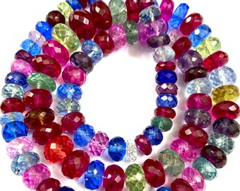 May include: A strand of faceted gemstone beads in various colors, including red, blue, green, and purple. The beads are strung on a clear thread and are ready to be used for jewelry making.