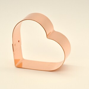 May include: A copper heart-shaped cookie cutter.