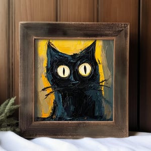 May include: A framed painting of a black cat with yellow eyes. The cat is painted in a stylized, impressionistic style with thick brushstrokes. The background is a yellow and brown color.