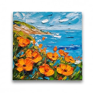 May include: Oil painting of a coastal landscape with vibrant orange poppies in the foreground. The artwork depicts a blue ocean, a green hillside, and a bright blue sky with textured brushstrokes. The painting is on a square canvas.