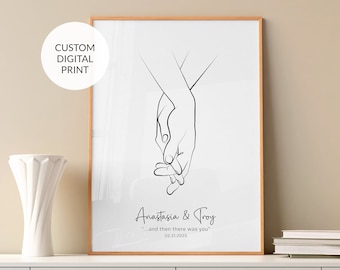 May include: A black and white line drawing of two hands holding each other. The text "Anastasia & Troy" is below the drawing, followed by the quote "...and then there was you" and the date "02.21.2023".