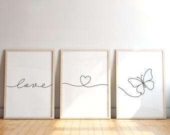 May include: Three framed minimalist art prints. The first print says "love" in cursive. The second print features a heart. The third print shows a butterfly. All prints have a black line drawing on a white background.