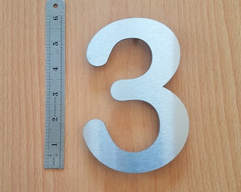 Large solid stainless steel self adhesive house/door numbers in Arial rounded with brush finish (6"/15cm)