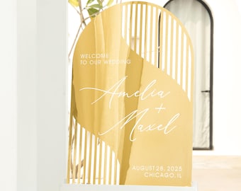 May include: Gold wedding welcome sign with a geometric design. The sign says "Welcome to our wedding" and features the names "Amelia + Maxel" and the date "August 28, 2025" and location "Chicago, IL".