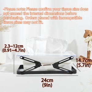 May include: A black tissue box holder with a clear lid, holding a stack of white tissues. The holder is 9 inches long and 5.7 inches high. The internal dimensions are 0.91 to 4.7 inches. The text on the image provides a note about tissue size.