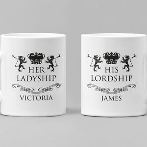 May include: Two white ceramic mugs with black text and images. The mug on the left says "Her Ladyship Victoria" and the mug on the right says "His Lordship James".