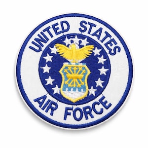 May include: Circular embroidered patch of the United States Air Force emblem. The blue border features white text: "UNITED STATES AIR FORCE." The centre displays a blue shield with a yellow eagle and stars, a symbol of the US Air Force.
