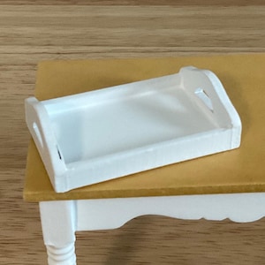 a white tray sitting on top of a wooden table