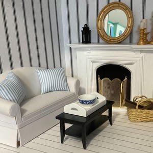 a living room with a white couch and a fireplace