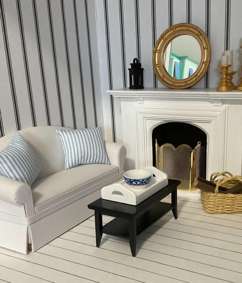 a living room with a white couch and a fireplace