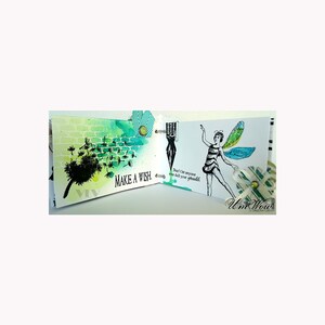 Puede incluir: Un diario hecho a mano con ilustraciones en acuarela y tinta. Una p&aacute;gina presenta un diente de le&oacute;n con el texto "MAKE A WISH". La p&aacute;gina opuesta muestra un hada con el texto "Don't let anyone ever dull your sparkle". El diario est&aacute; encuadernado con anillas met&aacute;licas.