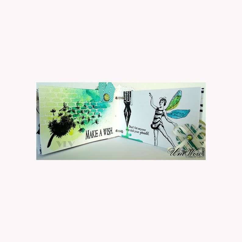 Puede incluir: Un diario hecho a mano con ilustraciones en acuarela y tinta. Una p&aacute;gina presenta un diente de le&oacute;n con el texto "MAKE A WISH". La p&aacute;gina opuesta muestra un hada con el texto "Don't let anyone ever dull your sparkle". El diario est&aacute; encuadernado con anillas met&aacute;licas.