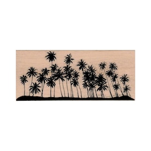 May include: A wood mounted rubber stamp with a silhouette of a row of palm trees against a light brown background.