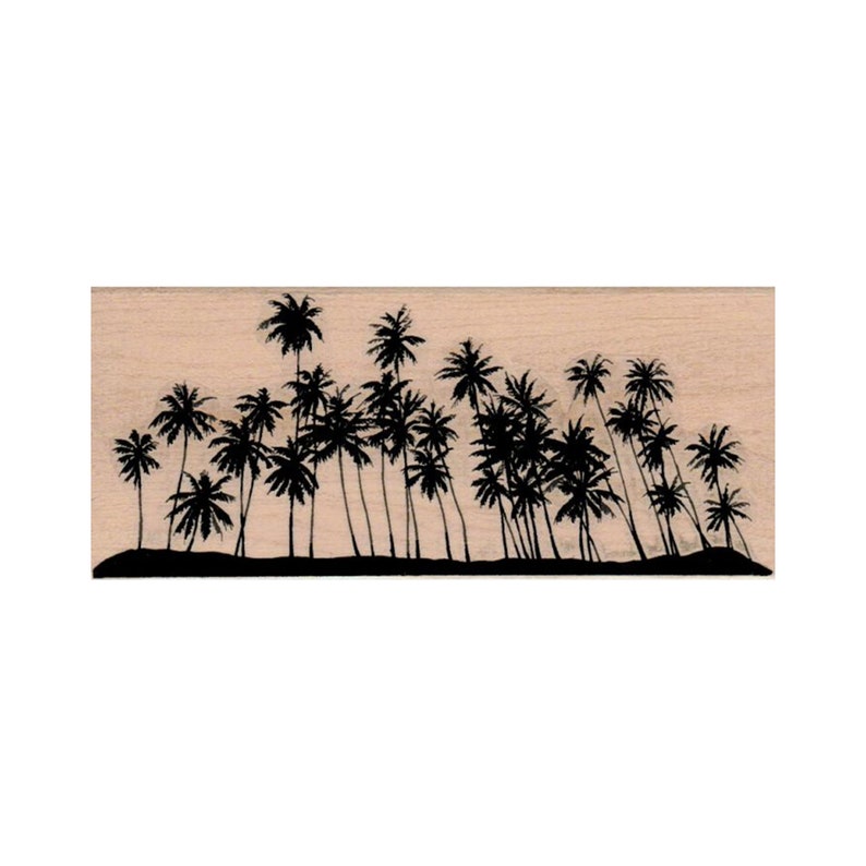 May include: A wood mounted rubber stamp with a silhouette of a row of palm trees against a light brown background.