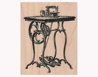 May include: A vintage sewing machine on a decorative metal stand with ornate scrollwork. The machine is black and has a wooden top.