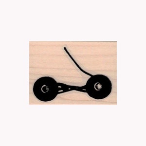 May include: A black rubber stamp with a design of a simple, stylized bicycle with two wheels.