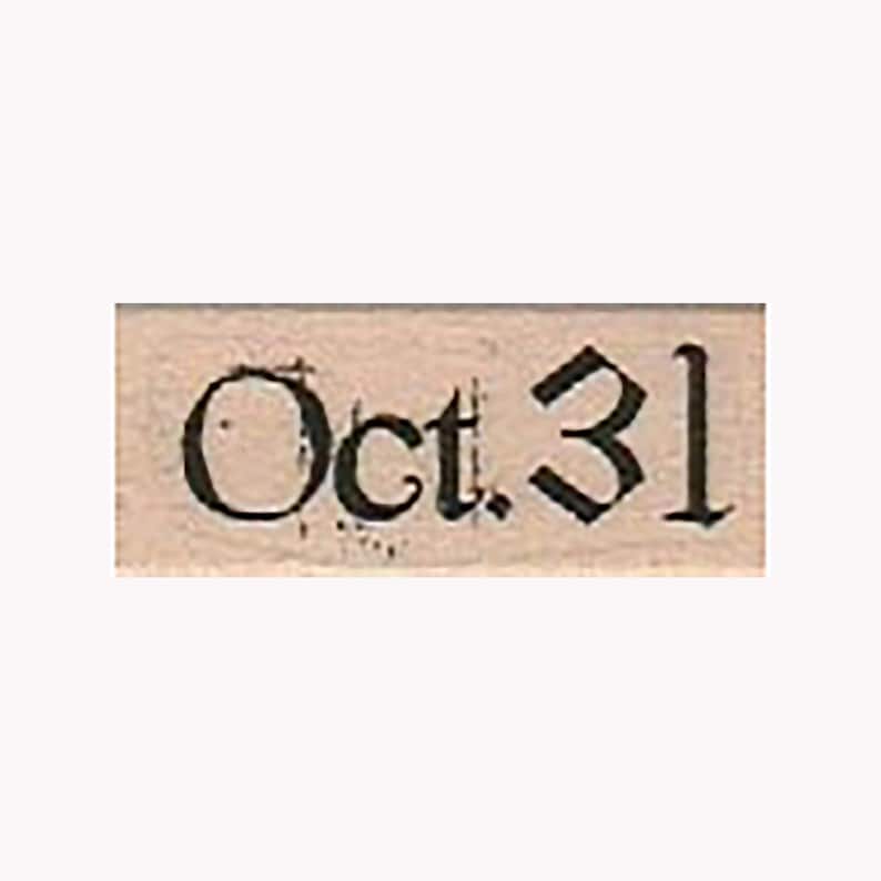 May include: A wooden stamp with the text "Oct. 31" in a black gothic font.